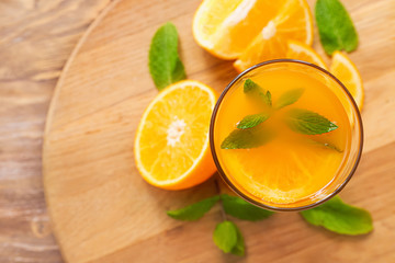 Glass of fresh orange juice on wooden table, closeup