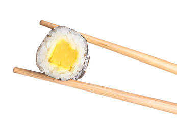 Chopsticks with tasty sushi roll on white background