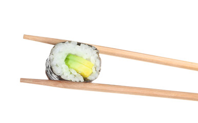 Chopsticks with tasty sushi roll on white background
