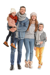 Portrait of happy family in autumn clothes on white background