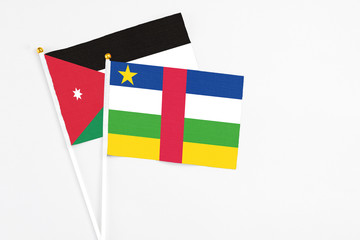 Central African Republic and Jordan stick flags on white background. High quality fabric, miniature national flag. Peaceful global concept.White floor for copy space.