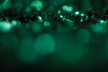 Monochrome emerald abstract background with bokeh defocused lights.