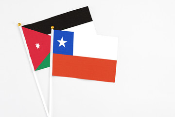 Chile and Jordan stick flags on white background. High quality fabric, miniature national flag. Peaceful global concept.White floor for copy space.