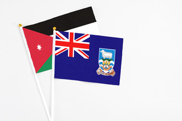 Falkland Islands and Jordan stick flags on white background. High quality fabric, miniature...