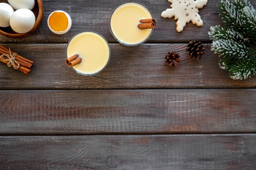 Make festive drink eggnog - ingredients on dark wooden background top view frame copy space