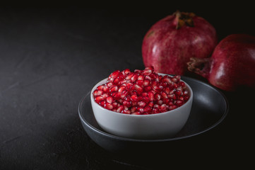 Ripe pomegranate fruits on the wooden background