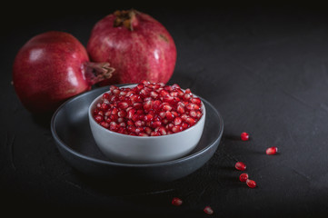 Ripe pomegranate fruits on the wooden background