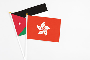 Hong Kong and Jordan stick flags on white background. High quality fabric, miniature national flag. Peaceful global concept.White floor for copy space.