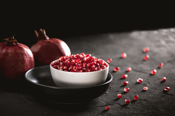 Ripe pomegranate fruits on the wooden background