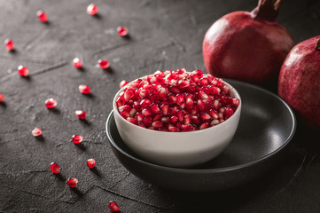 Ripe pomegranate fruits on the wooden background