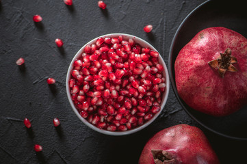 Ripe pomegranate fruits on the wooden background