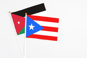 Puerto Rico and Jordan stick flags on white background. High quality fabric, miniature national flag. Peaceful global concept.White floor for copy space.