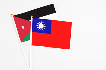 Taiwan and Jordan stick flags on white background. High quality fabric, miniature national flag. Peaceful global concept.White floor for copy space.