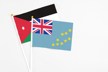 Fototapeta premium Tuvalu and Jordan stick flags on white background. High quality fabric, miniature national flag. Peaceful global concept.White floor for copy space.