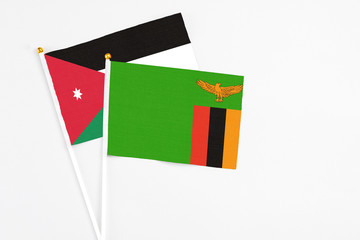 Zambia and Jordan stick flags on white background. High quality fabric, miniature national flag. Peaceful global concept.White floor for copy space.
