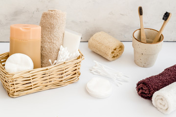 Bathroom accessories set with tooth brushes and towels on white background