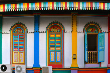 Restored historical building with colourful wooden shutters