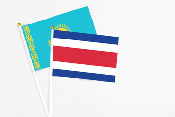 Costa Rica and Kazakhstan stick flags on white background. High quality fabric, miniature national flag. Peaceful global concept.White floor for copy space.