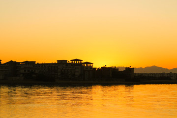 Fototapeta premium Beautiful bright yellow sunset over the tropical sea.