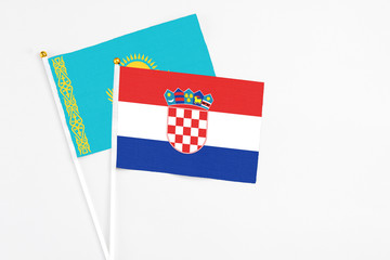 Croatia and Kazakhstan stick flags on white background. High quality fabric, miniature national...