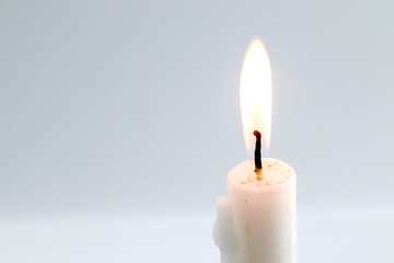 white candle on gray background