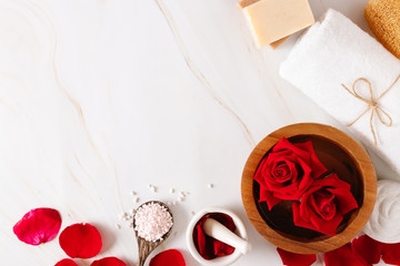 Spa bath product with rose oil and.Rose petals on a white background.