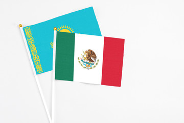 Mexico and Kazakhstan stick flags on white background. High quality fabric, miniature national flag. Peaceful global concept.White floor for copy space.