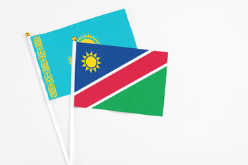 Namibia and Kazakhstan stick flags on white background. High quality fabric, miniature national flag. Peaceful global concept.White floor for copy space.