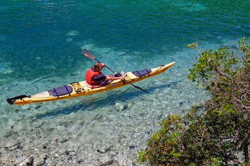 Man on sea kayak tour in Croatian Adriatic Sea
