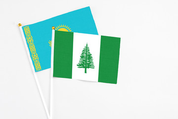 Norfolk Island and Kazakhstan stick flags on white background. High quality fabric, miniature national flag. Peaceful global concept.White floor for copy space.
