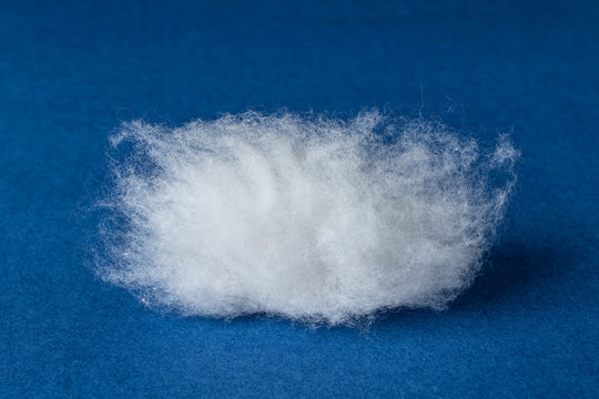 Closeup of a group of long velvet cotton material on a blue background