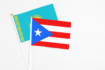 Puerto Rico and Kazakhstan stick flags on white background. High quality fabric, miniature national flag. Peaceful global concept.White floor for copy space.