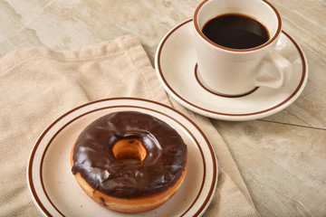 Chocolate frosted donut with coffee