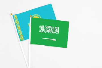Saudi Arabia and Kazakhstan stick flags on white background. High quality fabric, miniature national flag. Peaceful global concept.White floor for copy space.