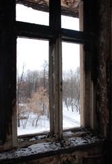 the view from the window of the burnt old building in winter.