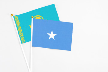 Somalia and Kazakhstan stick flags on white background. High quality fabric, miniature national flag. Peaceful global concept.White floor for copy space.