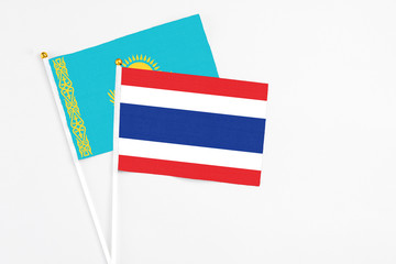 Thailand and Kazakhstan stick flags on white background. High quality fabric, miniature national flag. Peaceful global concept.White floor for copy space.