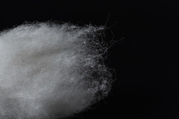 Closeup of a group of long-staple cotton material on a black background