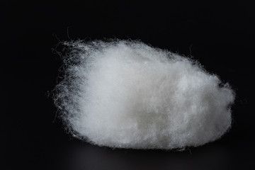 Closeup of a group of long-staple cotton material on a black background