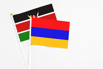 Armenia and Kenya stick flags on white background. High quality fabric, miniature national flag. Peaceful global concept.White floor for copy space.