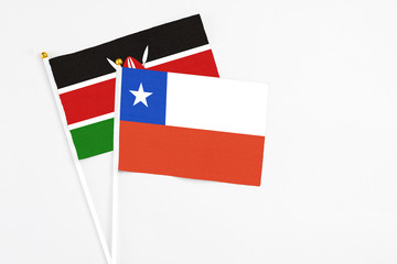Chile and Kenya stick flags on white background. High quality fabric, miniature national flag. Peaceful global concept.White floor for copy space.