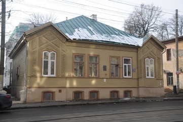 Old yellow merchant wooden house on the street of Nizhny 