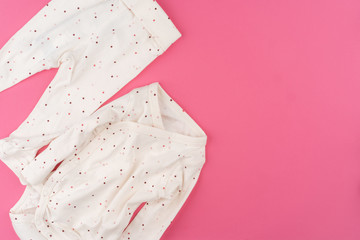 Obraz na płótnie Canvas baby clothes on pink background top view