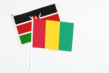 Guinea and Kenya stick flags on white background. High quality fabric, miniature national flag. Peaceful global concept.White floor for copy space.