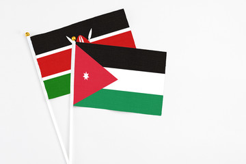 Jordan and Kenya stick flags on white background. High quality fabric, miniature national flag. Peaceful global concept.White floor for copy space.