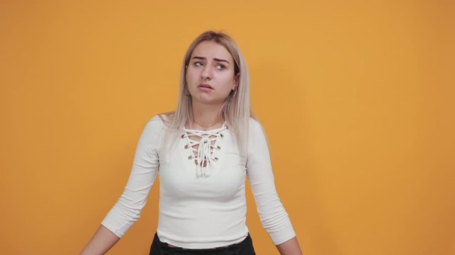 Young funny beautiful caucasian woman wearing nice white shirt puffing cheeks with funny face. Mouth inflated with air, crazy expression.
