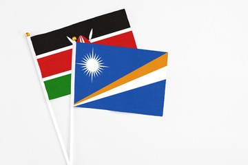 Marshall Islands and Kenya stick flags on white background. High quality fabric, miniature national...