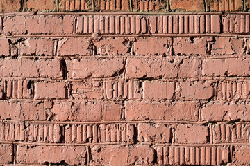 Weathered old brick wall painted brown paint. Abstract background