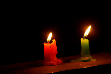 Burning candle in dark background. Closeup of candle with its flame