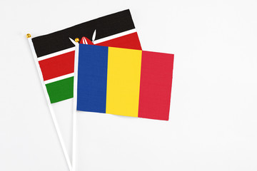 Romania and Kenya stick flags on white background. High quality fabric, miniature national flag. Peaceful global concept.White floor for copy space.